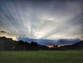 Scenic view of field against sky during sunset