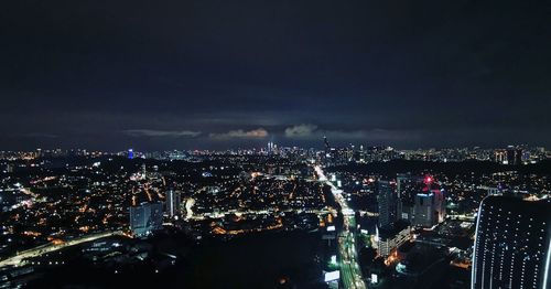 High angle view of city lit up at night