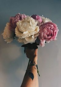 Midsection of woman holding bouquet