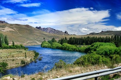 River amidst mountain range against sky