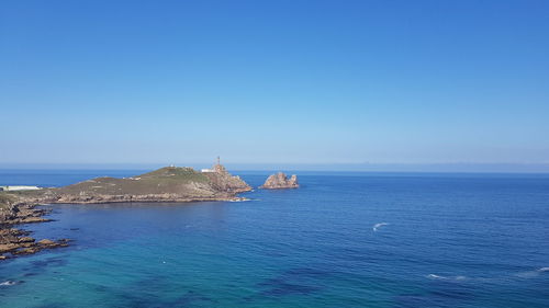 Scenic view of sea against clear blue sky