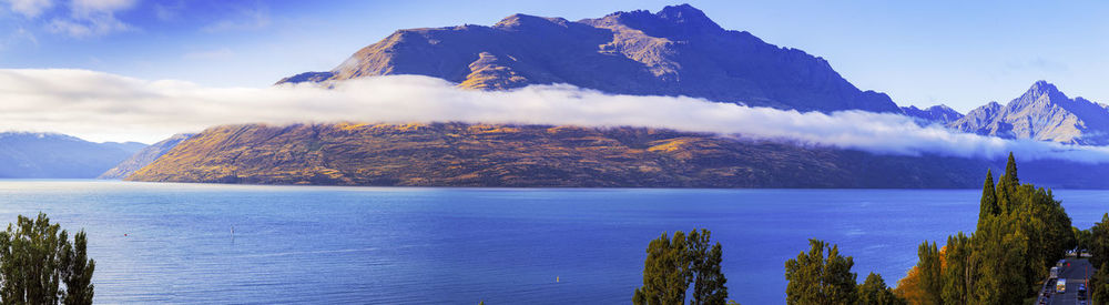 Panoramic view of sea and mountains against sky