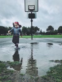 Full length of girl standing on water