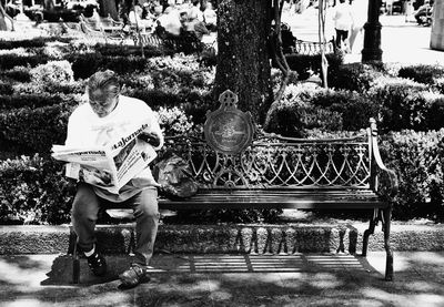 Man sitting on bench in park