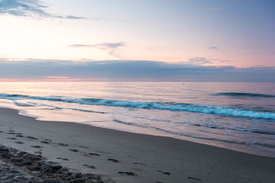 Scenic view of beach against sky during sunset