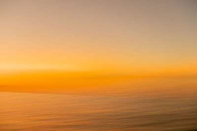 Scenic view of sea against clear sky during sunset