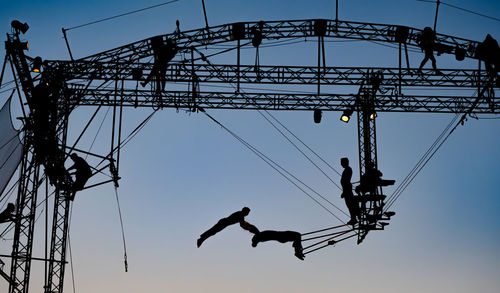 Sibiu, romania - 28 06 2022 silhouettes of trapeze artists acrobats from cirkvost, at the fits sibiu