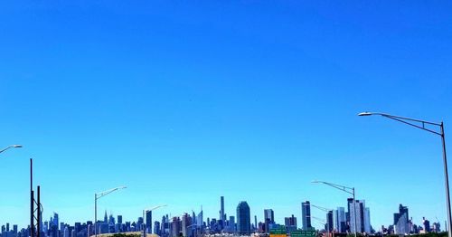 Modern buildings against clear blue sky