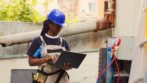 Rear view of man working at construction site