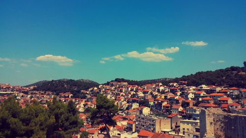 View of townscape against blue sky