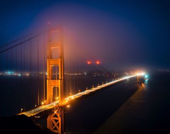 Light trails on suspension bridge at night