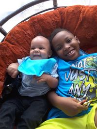 Portrait of cute smiling boy sitting outdoors