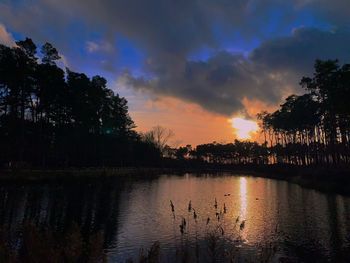 Scenic view of lake against sky during sunset