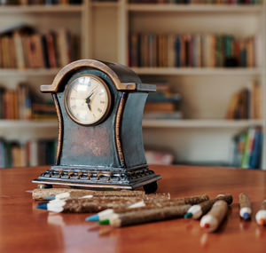 Close-up of clock on table at home