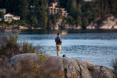 Man standing on rock at beach