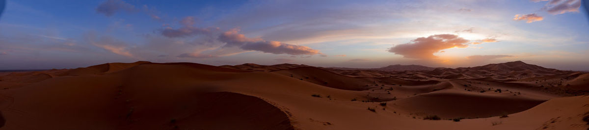 Scenic view of desert against sky during sunset