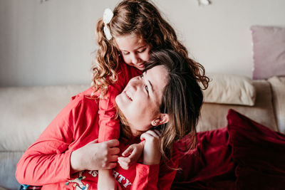 Happy mother and daughter spending leisure time at home