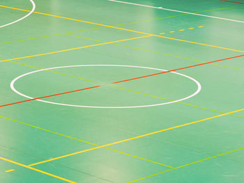 Green floor basketball court, old worn out scratches. lines on wooden floor of basketball court