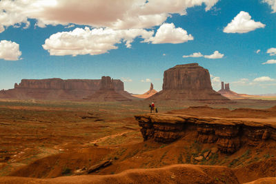 Scenic view of rock formations against cloudy sky