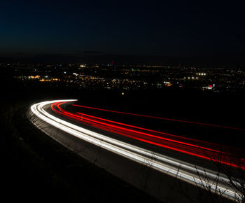 High angle view of light trails on road against sky at night