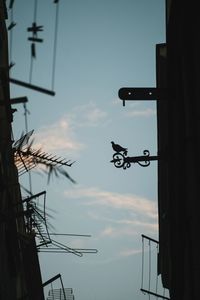 Low angle view of electricity pylon against sky