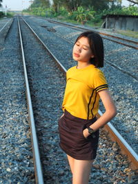 Full length of woman standing on railroad track
