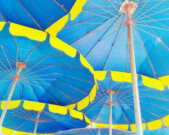 Low angle view of ferris wheel against blue sky