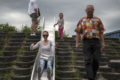 People standing on staircase against sky