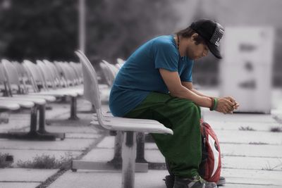 Young man sitting on seat