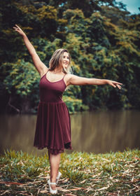 Full length of young woman standing on ground