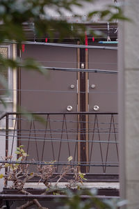 Close-up of metal fence against blue sky