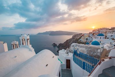 Panoramic view of buildings against cloudy sky