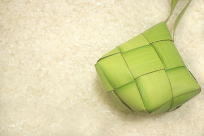 Ketupat with rice background