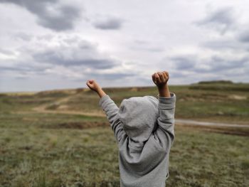 Midsection of man on field against sky