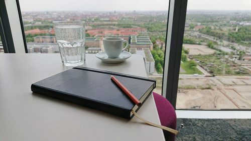 High angle view of laptop on table by window