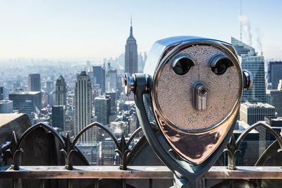 Coin-operated binoculars at observation point against sky