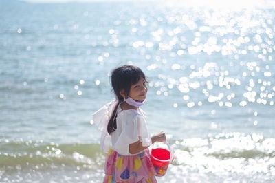 Girl standing on sea shore