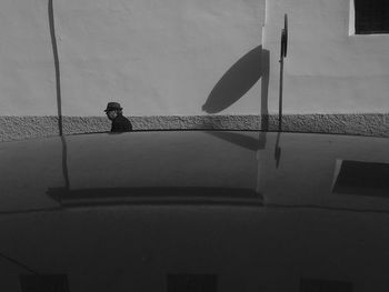 Man on building against sky