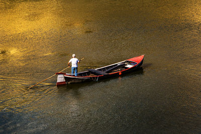 Man sitting in boat on lake