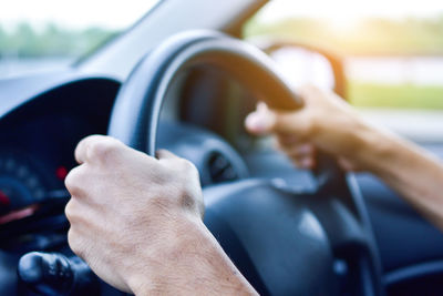 Cropped hands driving car