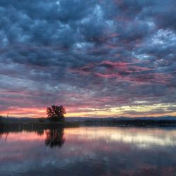 Scenic view of lake against dramatic sky