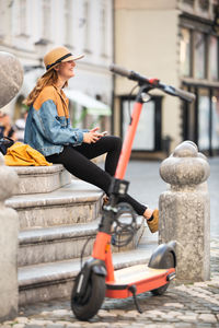 Woman looking at camera while sitting outdoors