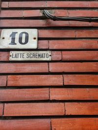 Low angle view of text on brick wall