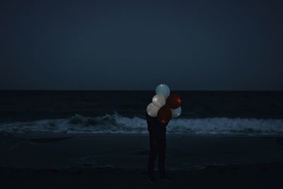 Rear view of man standing on beach