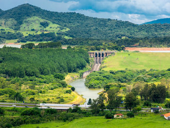 Scenic view of bridge over mountain against sky