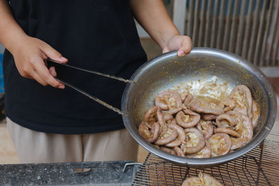 Midsection of person preparing food on table