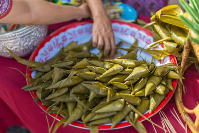 Close-up of woman holding vegetables at market stall