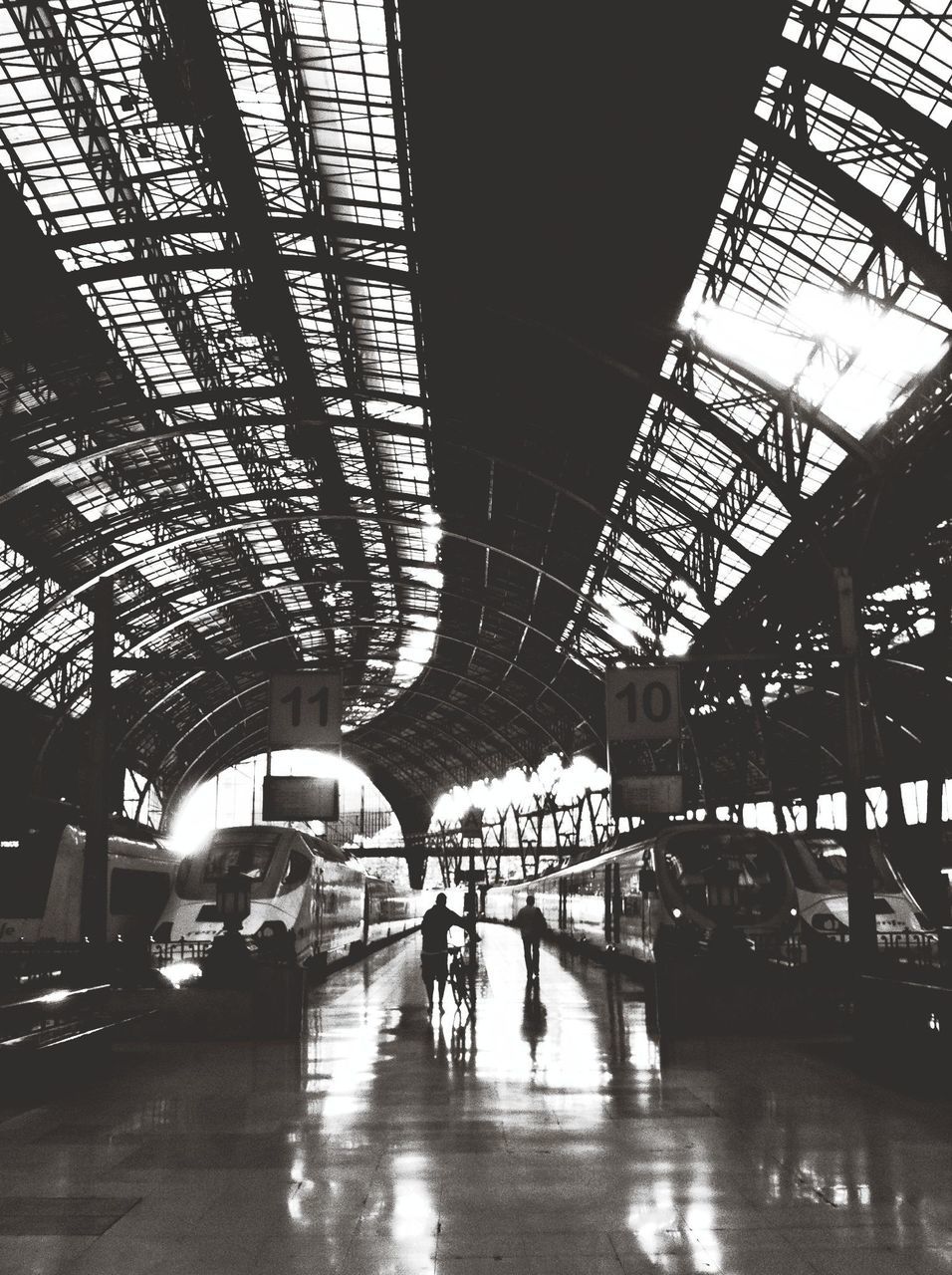 indoors, built structure, architecture, ceiling, men, reflection, lifestyles, person, walking, transportation, illuminated, incidental people, leisure activity, medium group of people, railroad station, city life, large group of people, full length, connection