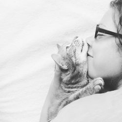Close-up of woman kissing cat
