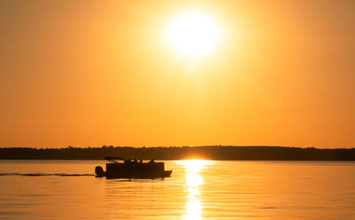 Silhouette boat against sky during sunset